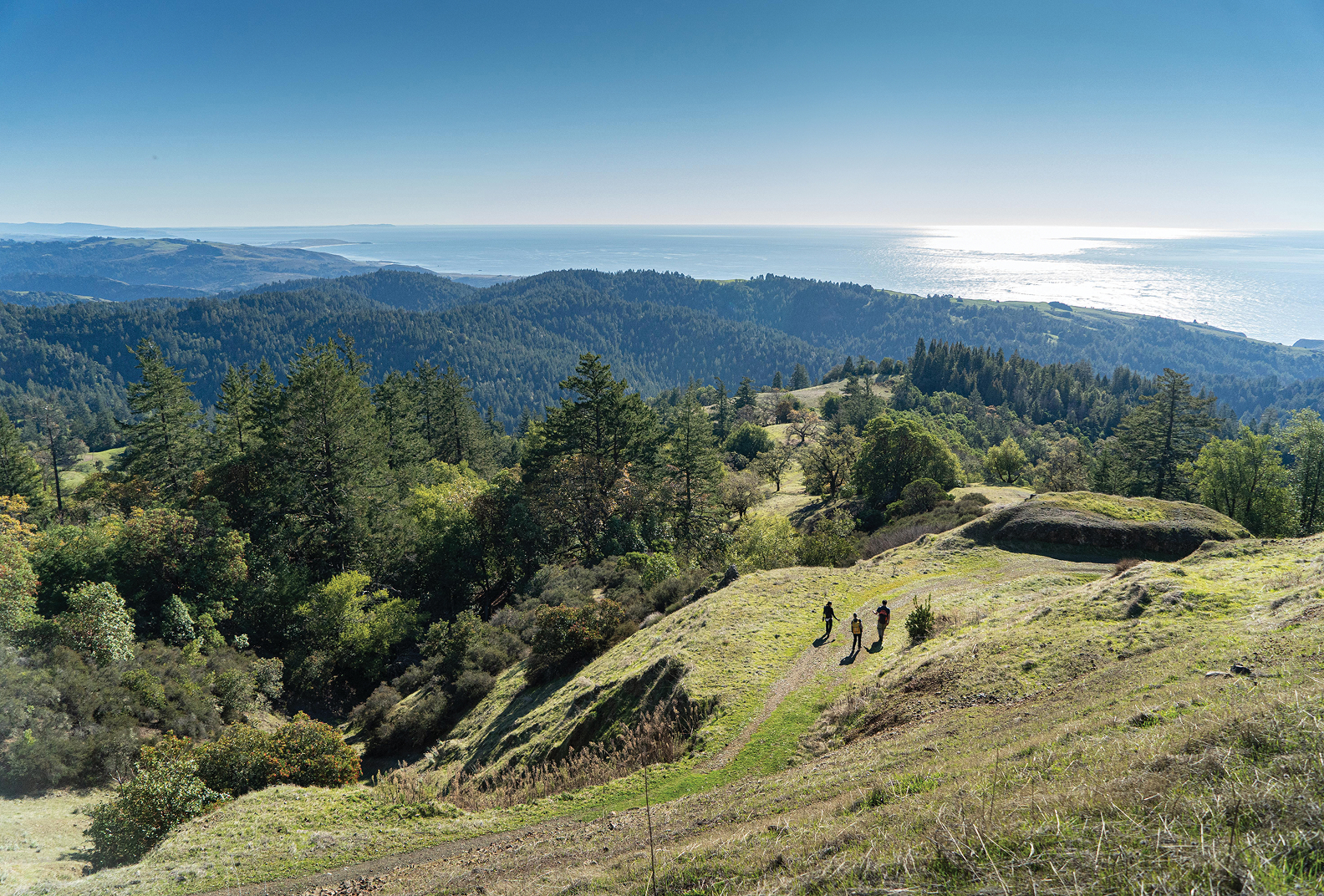 A scenic view of hikers traversing a trail at Pole Mountain.