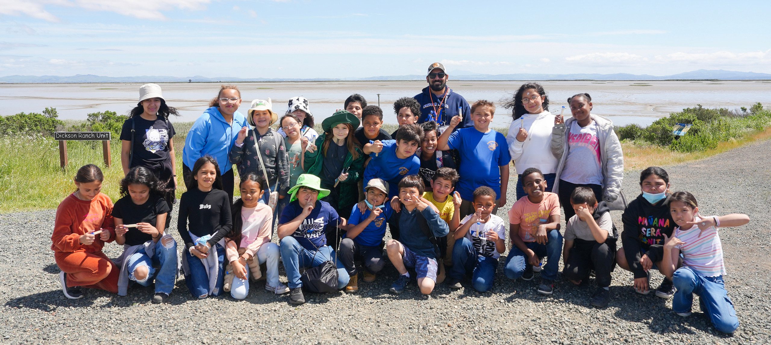 A group of elementary school field trip participants pose together at Sears Point Marsh.