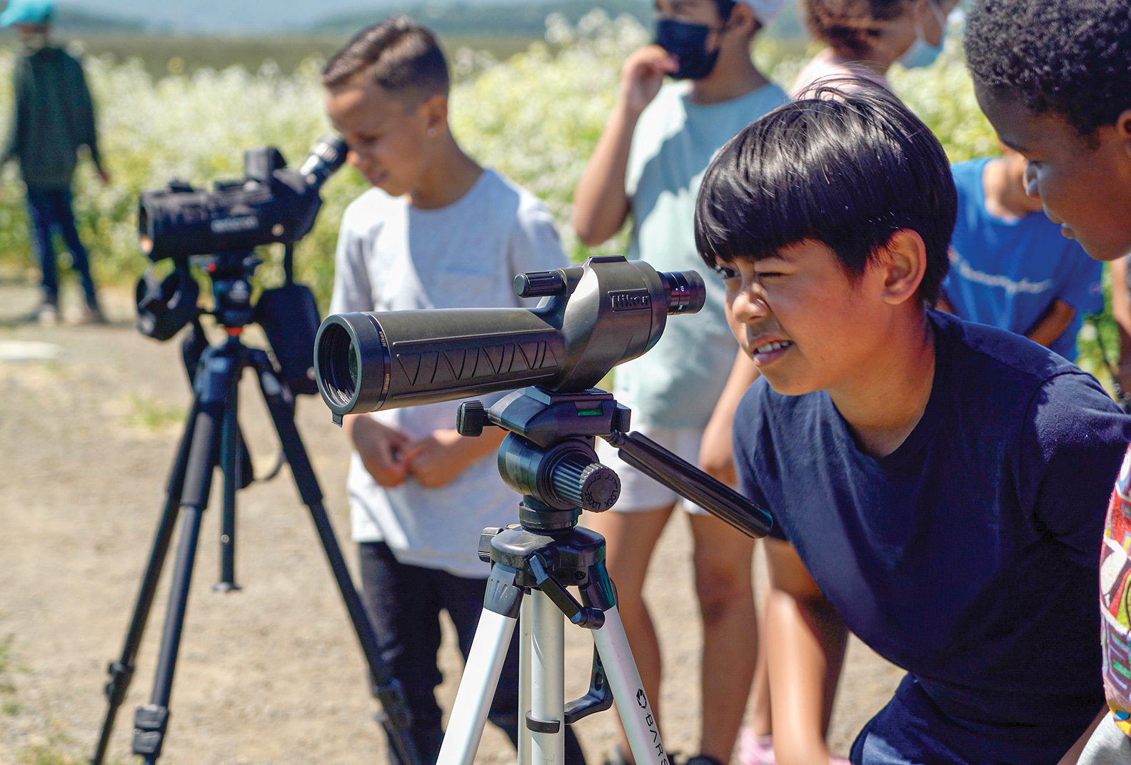 Students using telescopes outdoors