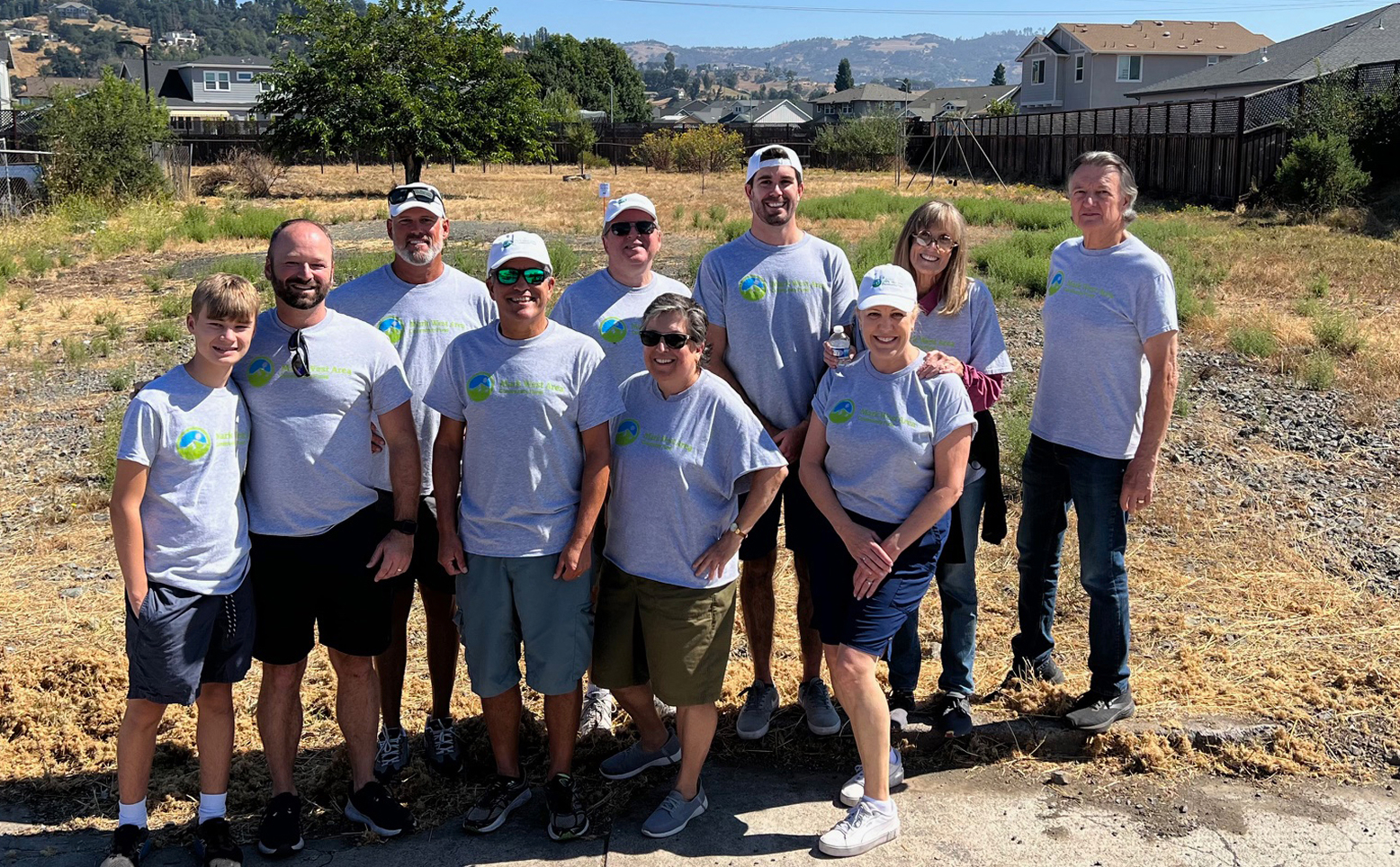 Volunteers in matching t-shirts posing for a picture at Mark West Community Park