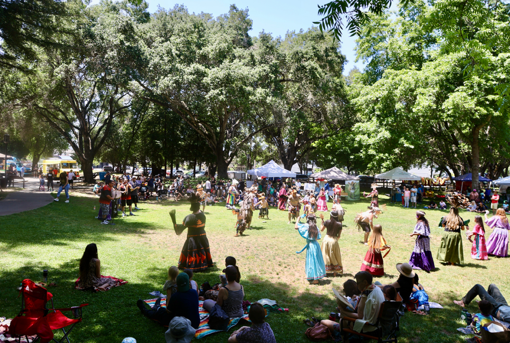 Child in the Wild event with performers and attendees.