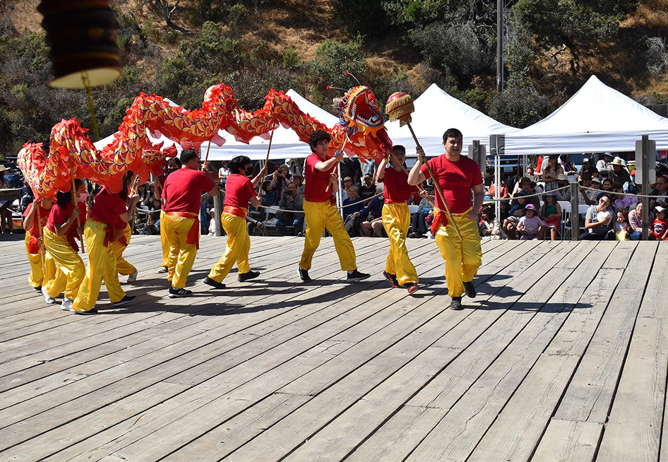 Chinese dragon puppet with performers at an event.