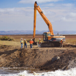 Construction equipment at a levee breach.