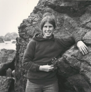 Marilyn Goode smiling while leaning on a rock.
